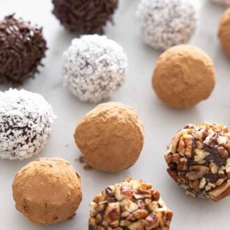 Rows of chocolate truffles with assorted coatings.