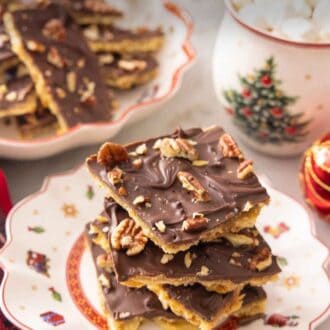 Pinterest graphic of a plate of Christmas crackers stacked on top.