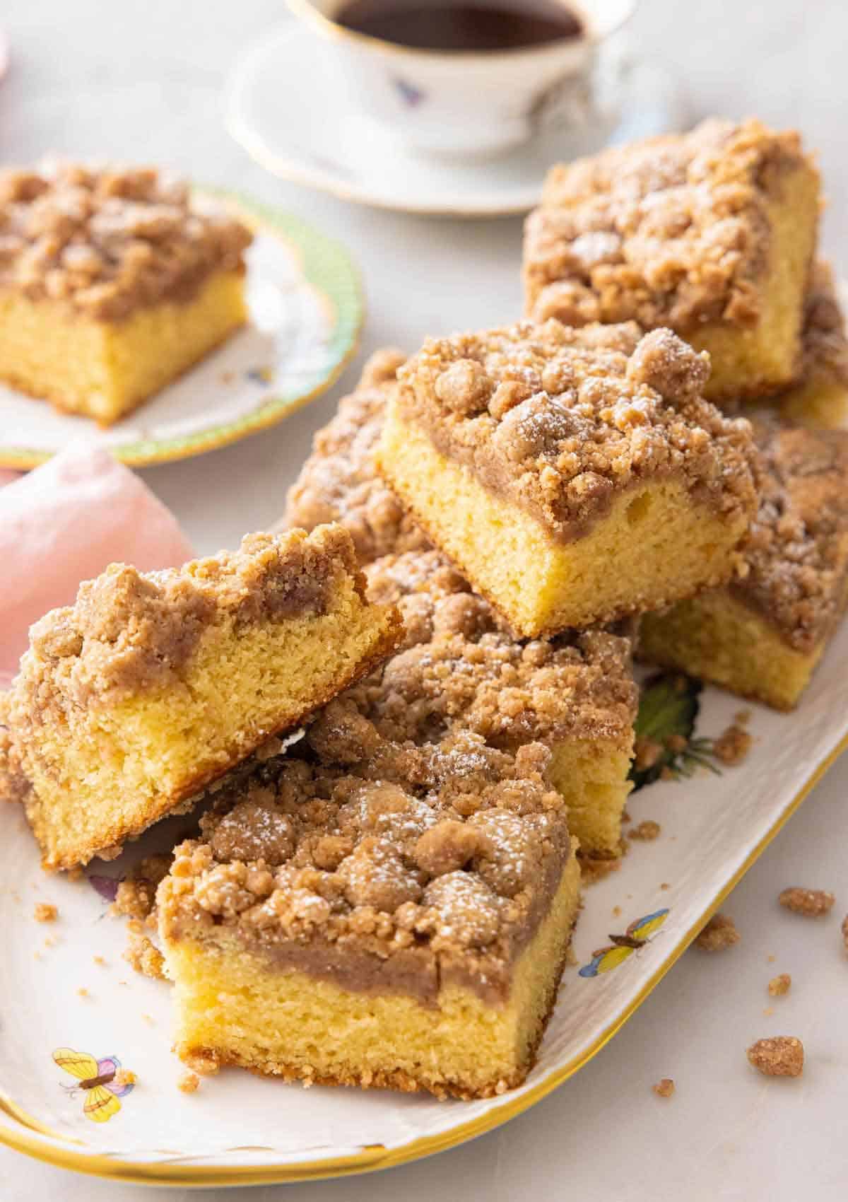 A platter of square pieces of crumb cake.