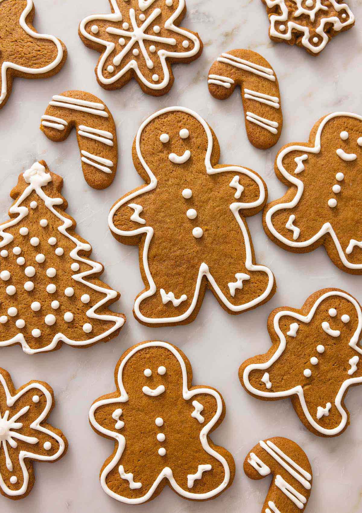 Gingerbread cookies in a shape of trees, people, candy canes, and snowflakes.
