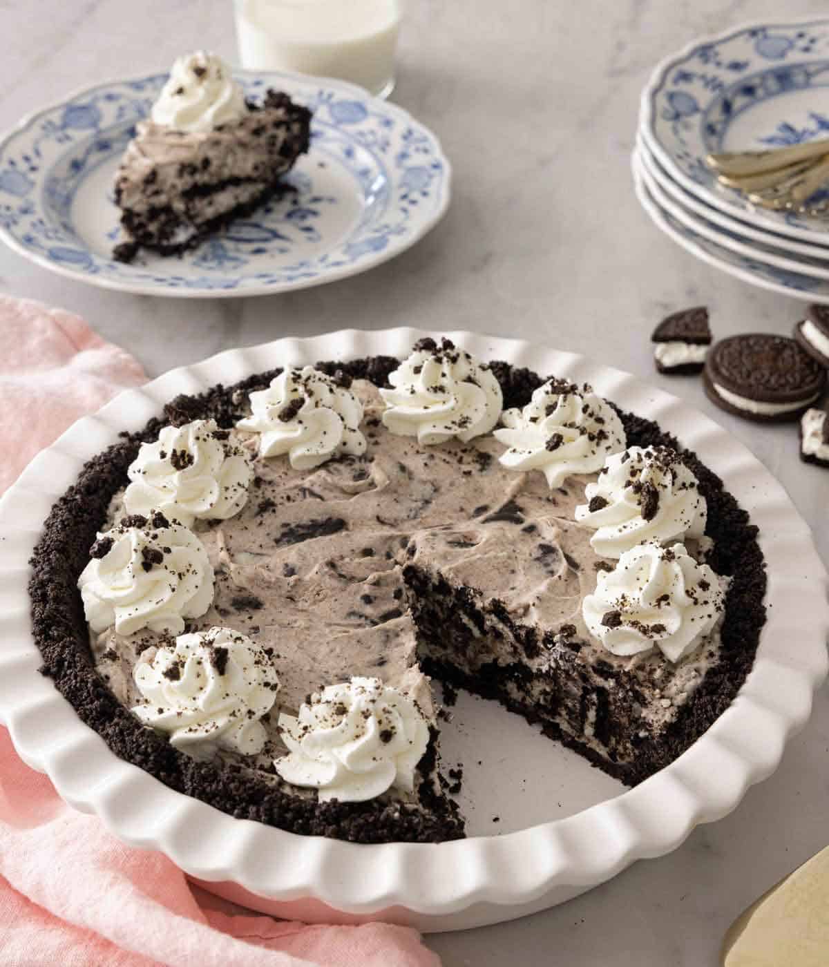 An Oreo pie in its baking dish with a slice cut out.