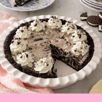 Pinterest graphic of an Oreo pie in its baking dish with a slice cut out.