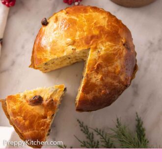 Pinterest graphic of an overhead view of a loaf of panettone with a slice pulled out.