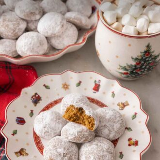 Pinterest graphic of a small plate with multiple Pfeffernusse in front of hot chocolate and a platter.