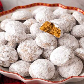 A platter of Pfeffernusse with one showing the cross section.