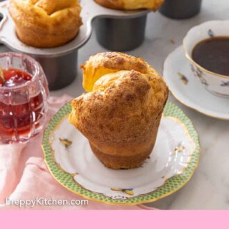 Pinterest graphic of a plate with a popover with a cup of coffee and jam beside it.