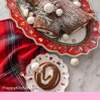 Pinterest graphic of a plate with a sliced piece of Buche de Noel in front of a platter with the rest of the cake.
