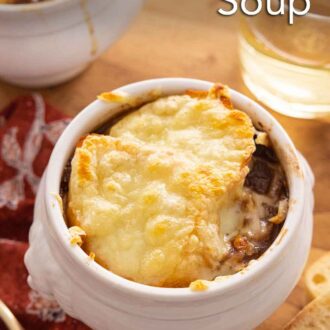 Pinterest graphic of a bowl of French onion soup with wine beside it.