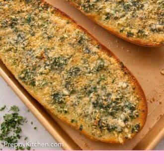 Pinterest graphic of garlic bread on a sheet pan.