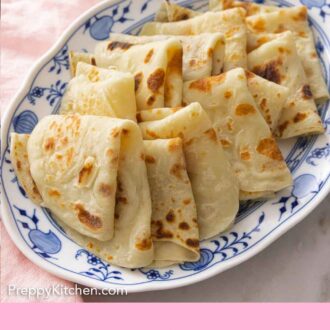 Pinterest graphic of a platter of folded lefse.