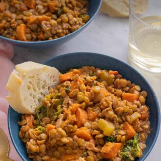 Pinterest graphic of a bowl of lentil soup with bread.