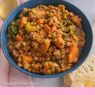 Pinterest graphic of a blue bowl of lentil soup.