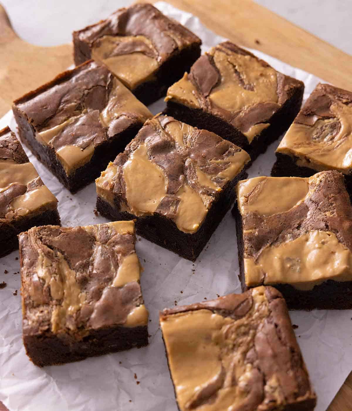 Cut peanut butter brownies on top of a serving board.