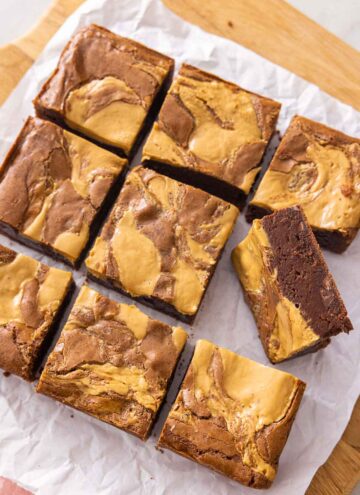 A cutting board of peanut butter brownies cut into 9 servings.
