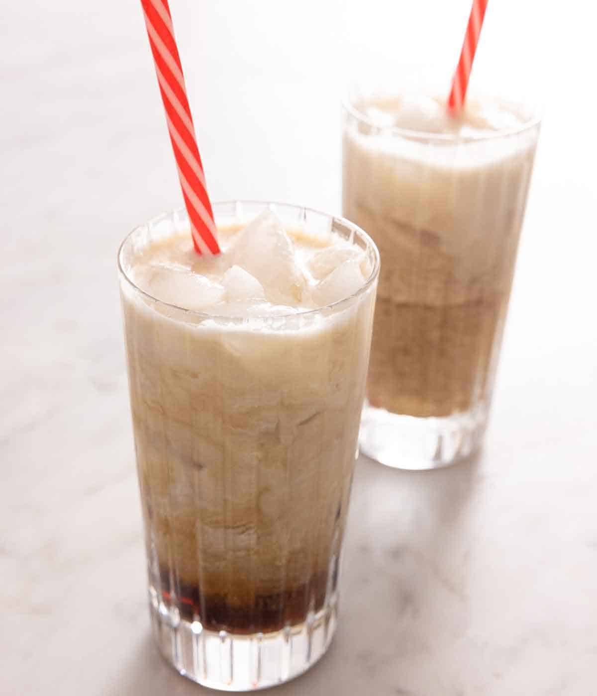 Two glasses of Colorado Bulldogs with a red and white straw in each.