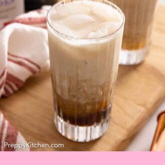 Pinterest graphic of a glass of Colorado Bulldog with another glass and ingredients in the background.