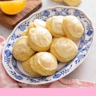Pinterest graphic of a platter of orange cookies with orange wedges in the background.