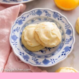 Pinterest graphic of a plate of two orange cookies with an orange wedge in the background.
