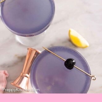 Pinterest graphic of an overhead view of two glasses of Aviation cocktails with a cocktail cherry garnish.