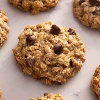 A single layer of banana oatmeal cookies on a marble surface.