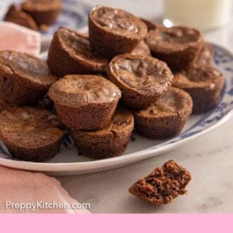 Pinterest graphic of a platter of brownie bites with a glass of milk in the background.