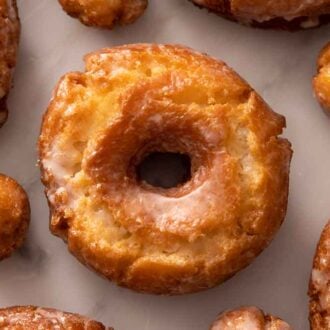 Old fashioned donuts and donut holes in a single layer.