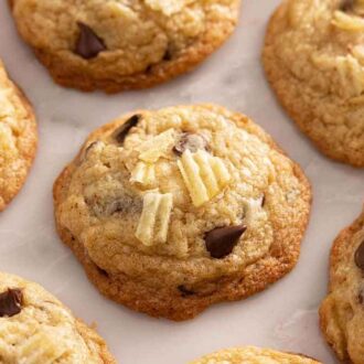 A single layer of potato chip cookies on a marble surface.