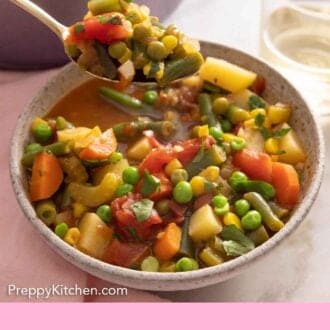 Pinterest graphic of a spoonful of vegetable soup lifted from the bowl.