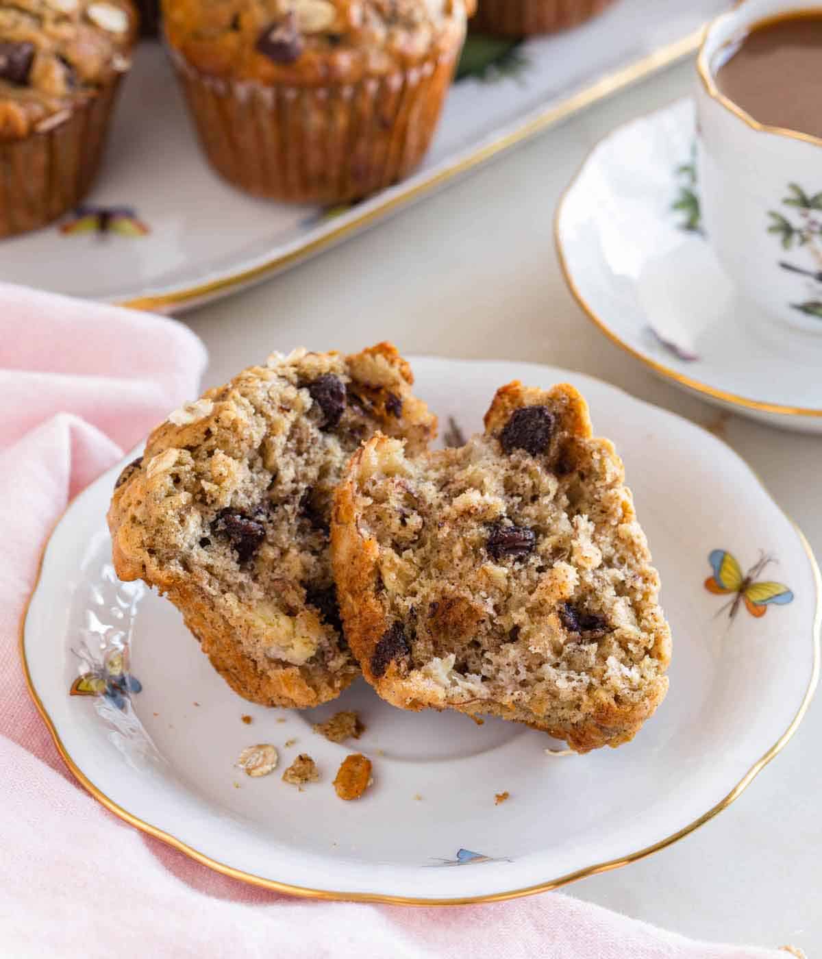 A plate with a banana oatmeal muffins, split in half.