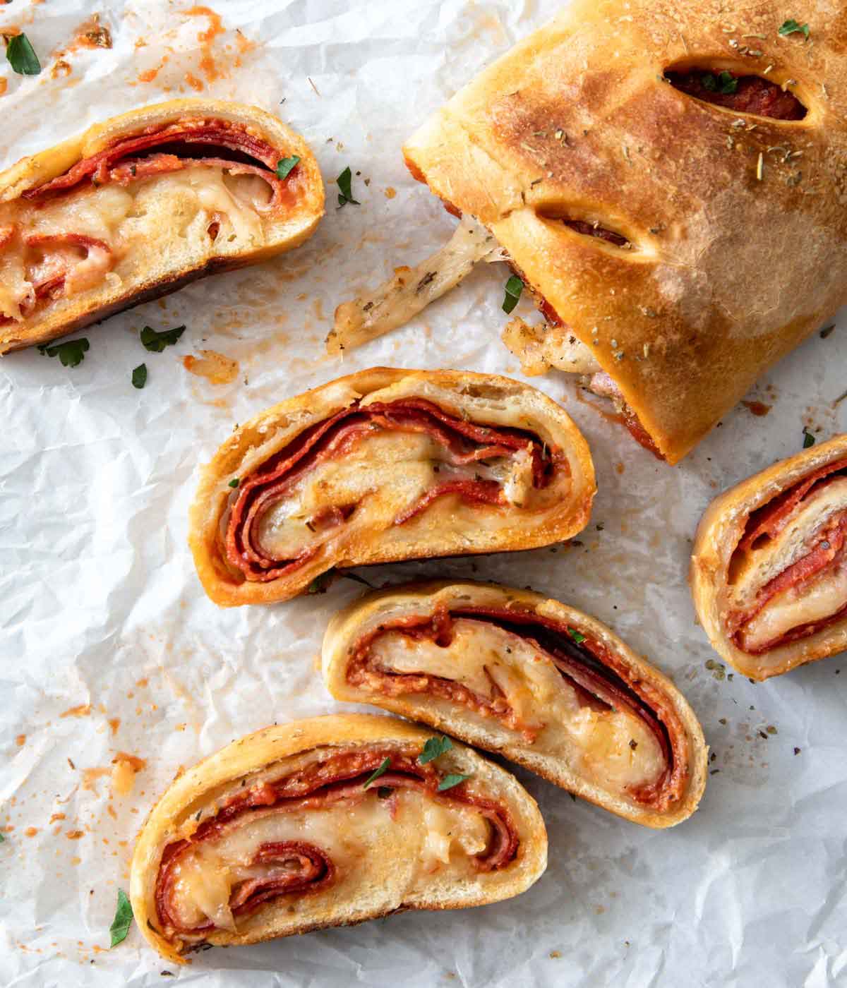 Overhead view of pieces of stromboli sliced and showing the interior layers.
