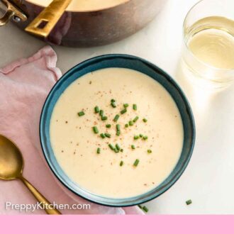 Pinterest graphic of a bowl of vichyssoise by a glass of wine and pot of soup.