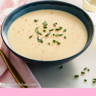 Pinterest graphic of a bowl of vichyssoise with freshly chopped chives on top.