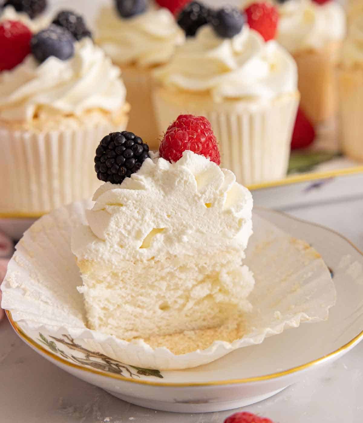 Half of an angel food cupcake on a plate.