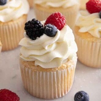 Multiple angel food cupcakes with one in focus.