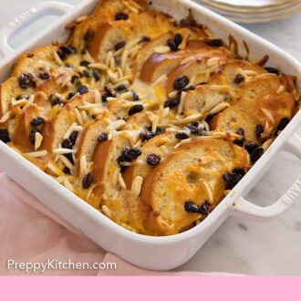 Pinterest graphic of a baking dish of capirotada with a stack of plates in the back.