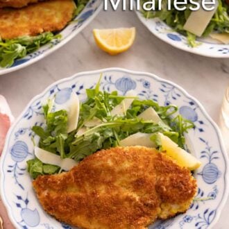 Pinterest graphic of a plate of chicken Milanese with a side of arugula salad.