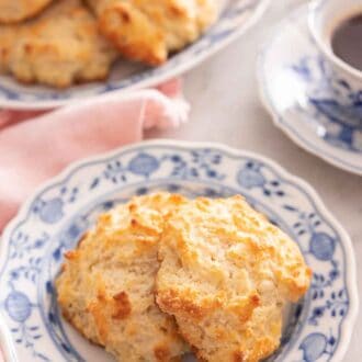 Pinterest graphic of a plate with two drop biscuits.
