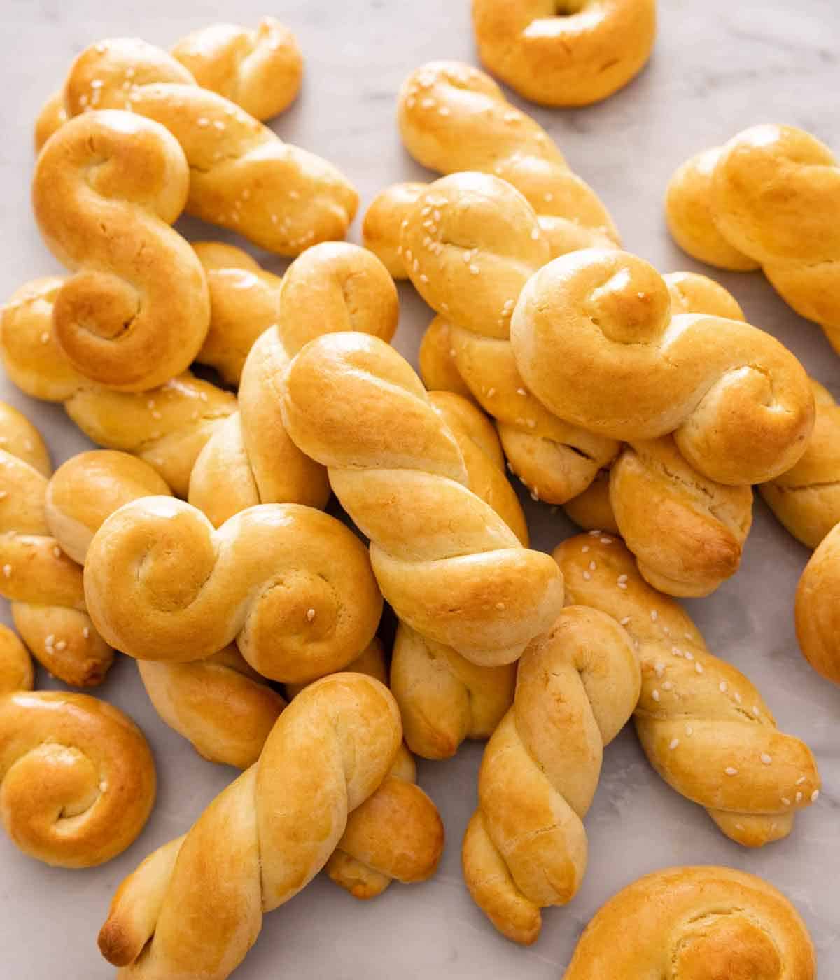 Multiple koulourakia in a pile on a marble surface.