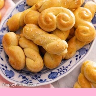 Pinterest graphic of a blue and white platter of koulourakia.