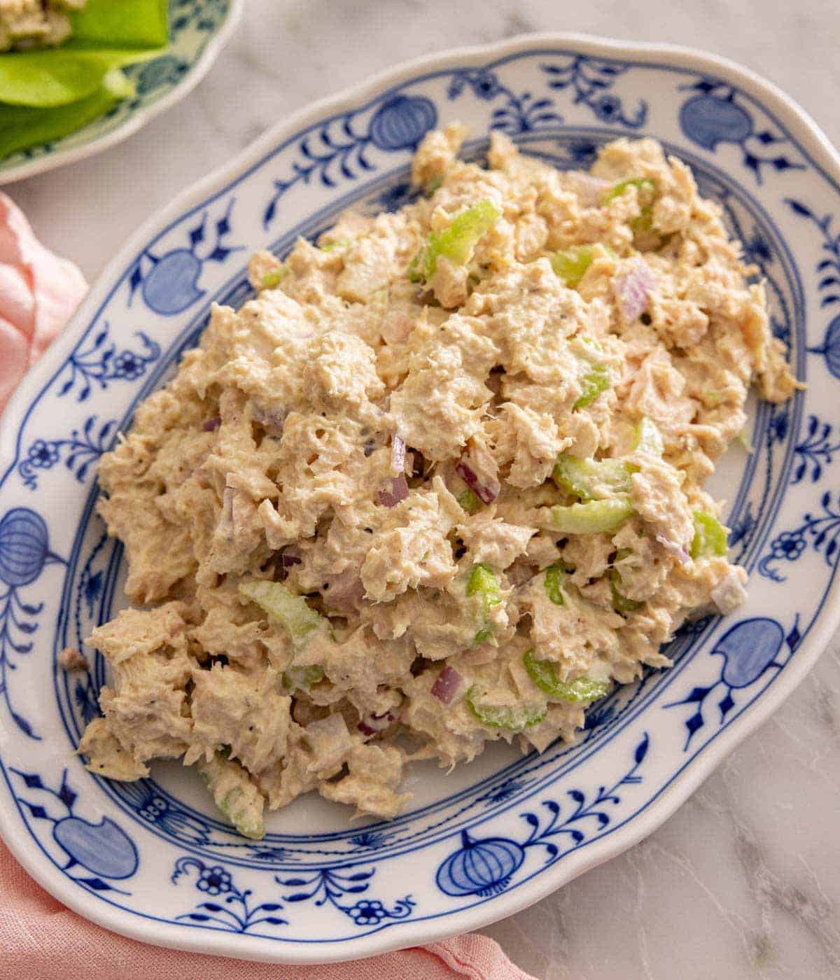 Overhead view of an oval platter of tuna salad.