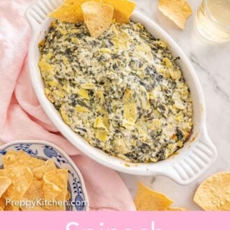 Pinterest graphic of a baking dish of spinach artichoke dip with chips stuck on the side and more scattered around.