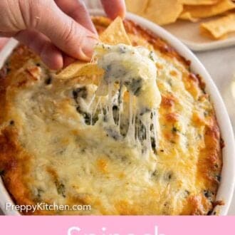 Pinterest graphic of a chip scooping up spinach artichoke dip with a cheese pull.