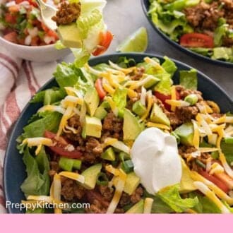 Pinterest graphic of a forkful of taco salad lifted from the bowl.