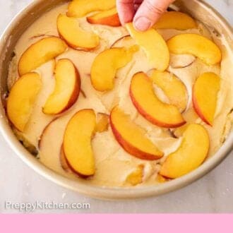 Pinterest graphic of sliced peaches placed on top of cake batter.