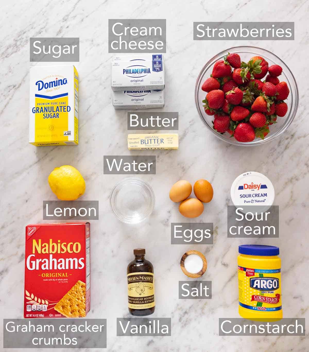 Ingredients needed to make a strawberry cheesecake.