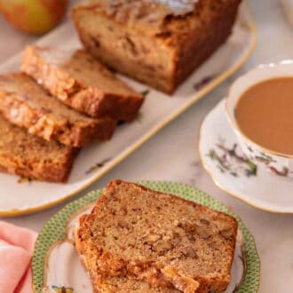 Pinterest graphic of a plate with two slices of apple bread with the rest of the loaf in the background, half cut.