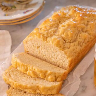 Pinterest graphic of a loaf of beer bread with three slices of bread cut in front.