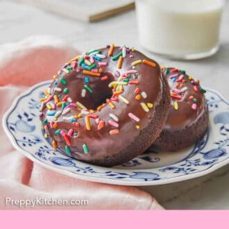 Pinterest graphic of a plate of two chocolate donuts with rainbow sprinkles on top.