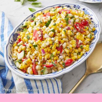Pinterest graphic of a large oval platter of corn salad with basil leaves scattered in the back.