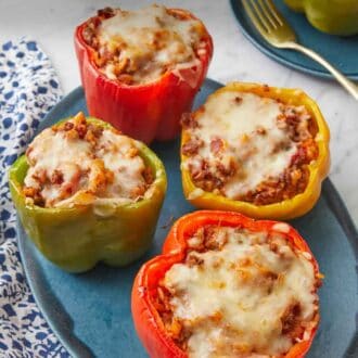 Pinterest graphic of a platter with four stuffed peppers.